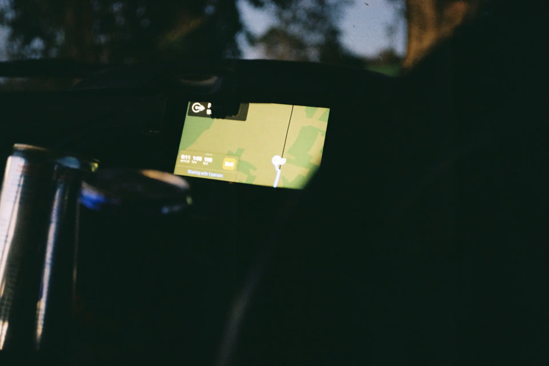 phone in car displaying apple maps