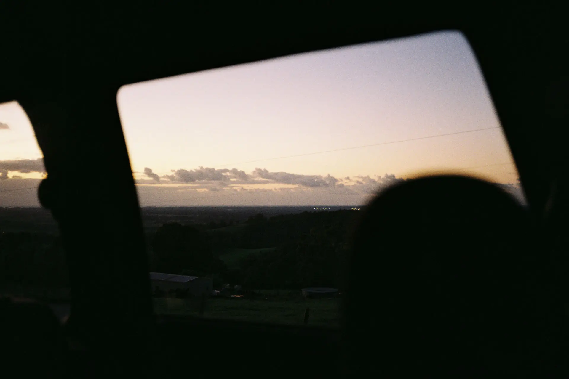 looking out of car window at sunset